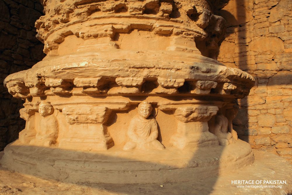 Ornate stone capital displays carved geometric and spherical motifs.